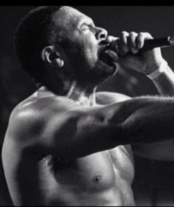 C.L. Smooth performing with a microphone, black and white.