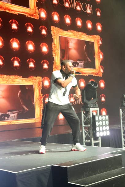 C.L. Smooth commanding the stage, microphone raised mid-verse.