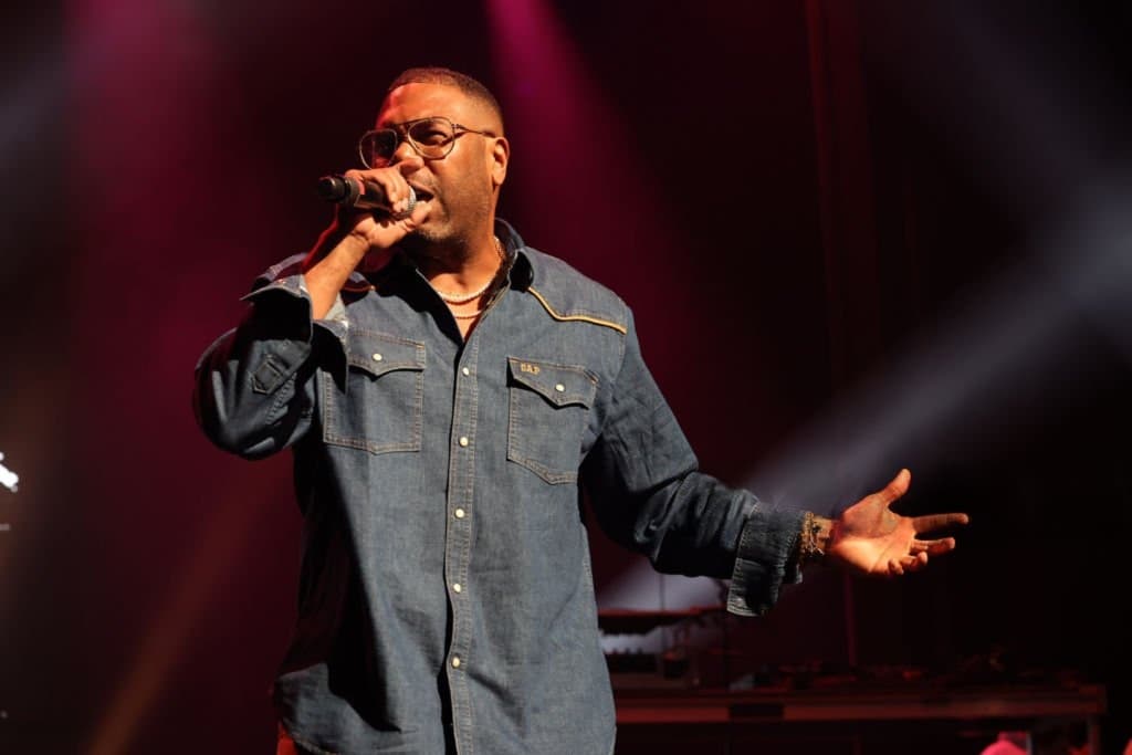 C.L. Smooth performing, microphone in hand.
