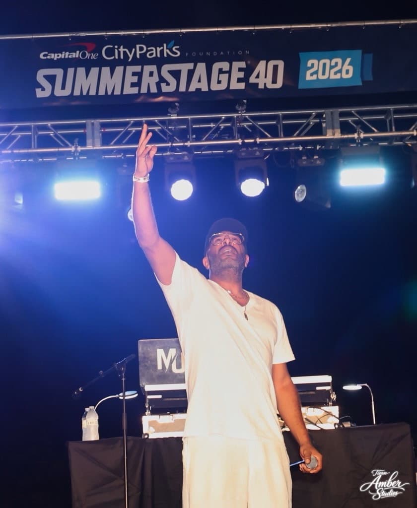 C.L. Smooth performing at SummerStage 2026, arm raised to the crowd.